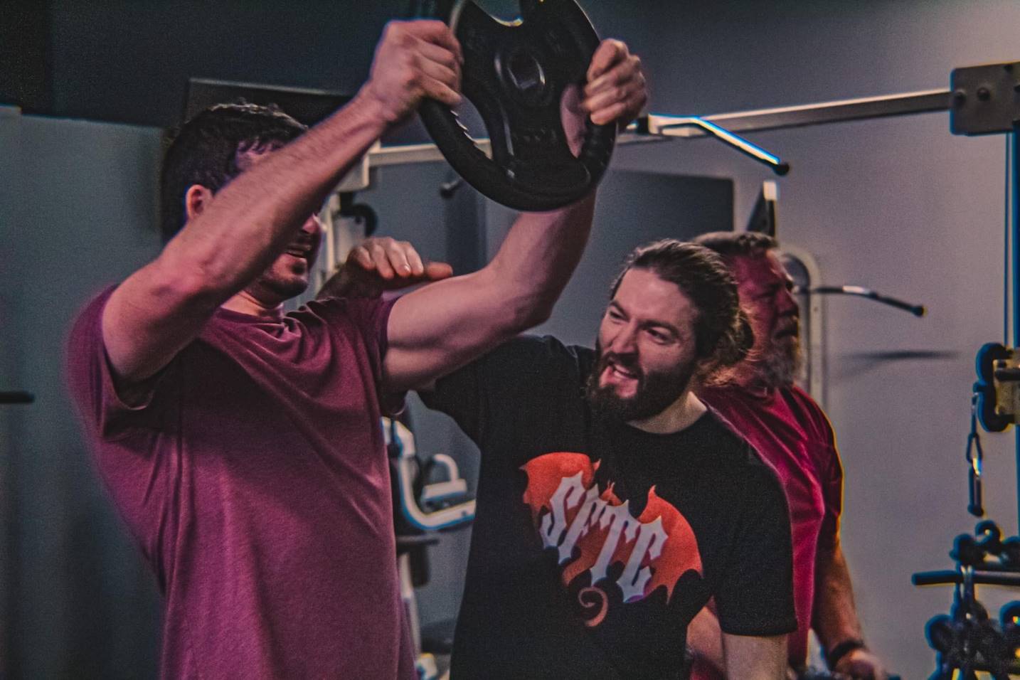 Adam demonstrating form with a member during a personal training session.